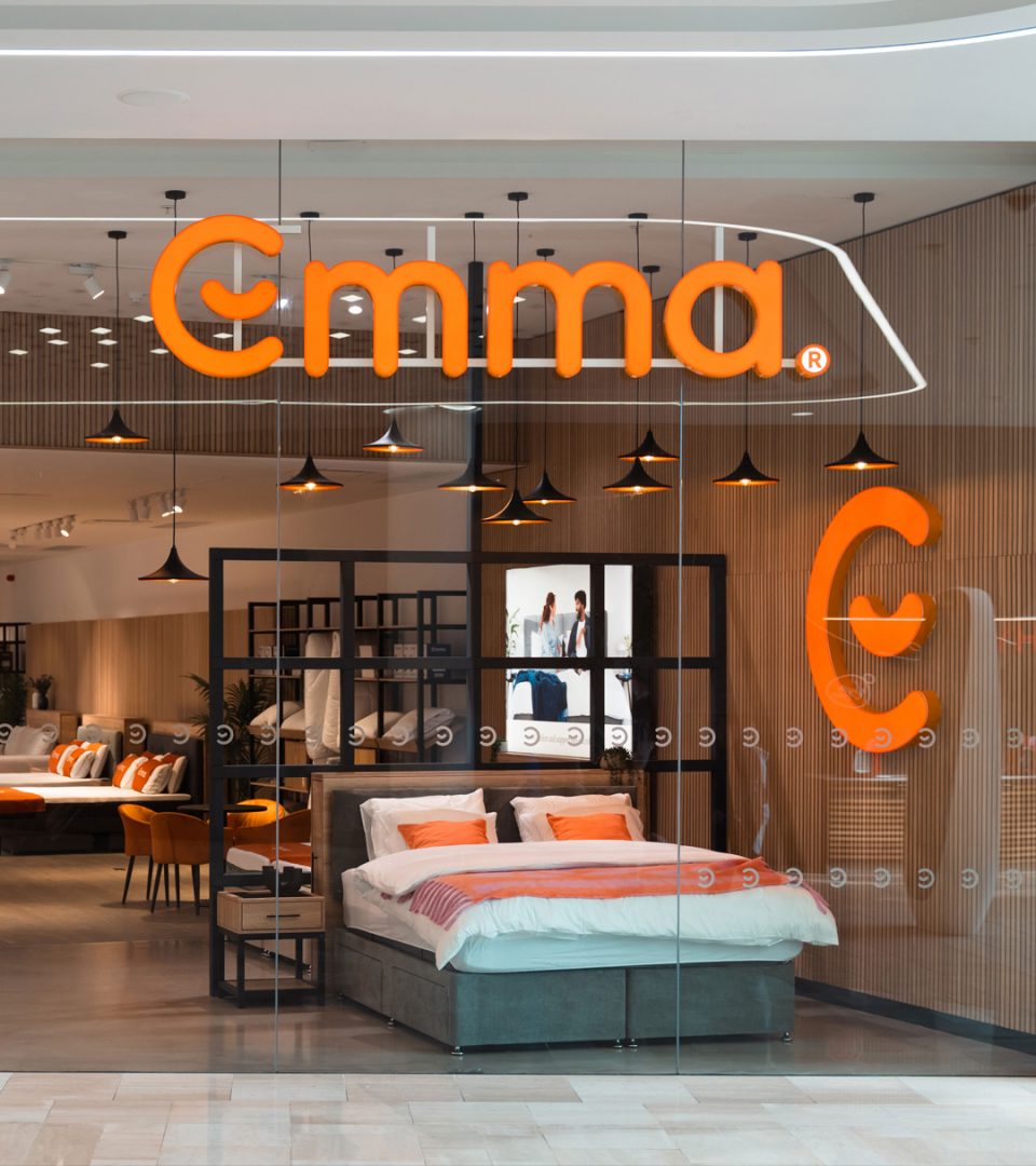 shop front with bed behind glass window